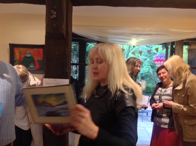 Hostess Irina says goodbye to her beloved picture which she donated to the CRF.